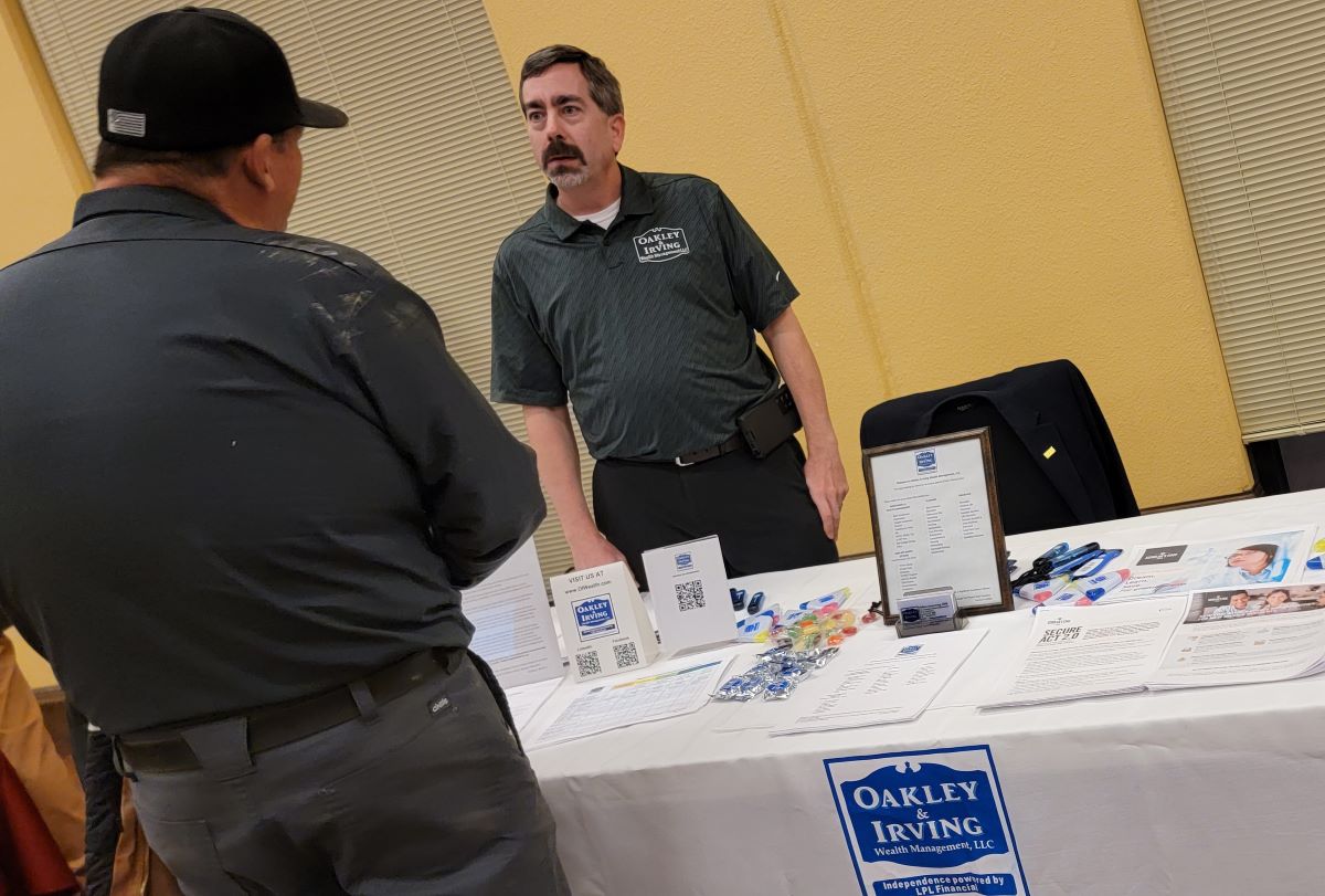  Financial Advisor of Oakley & Irving Wealth Management listening to a client 