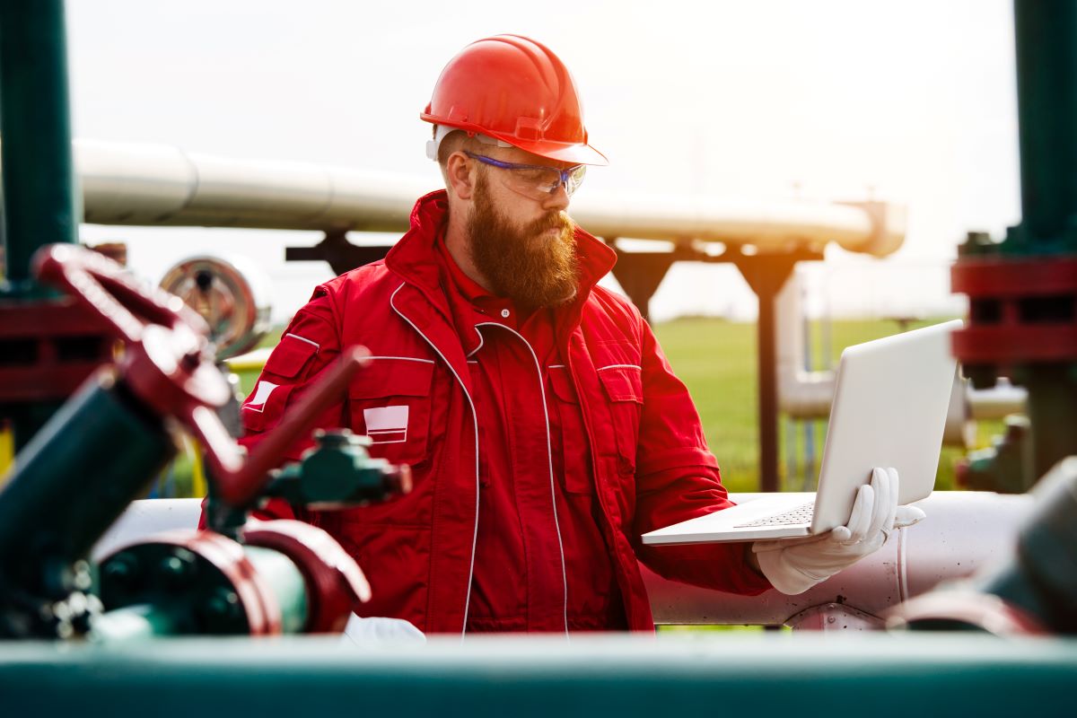 Oil Industry Engineer making report on his laptop
